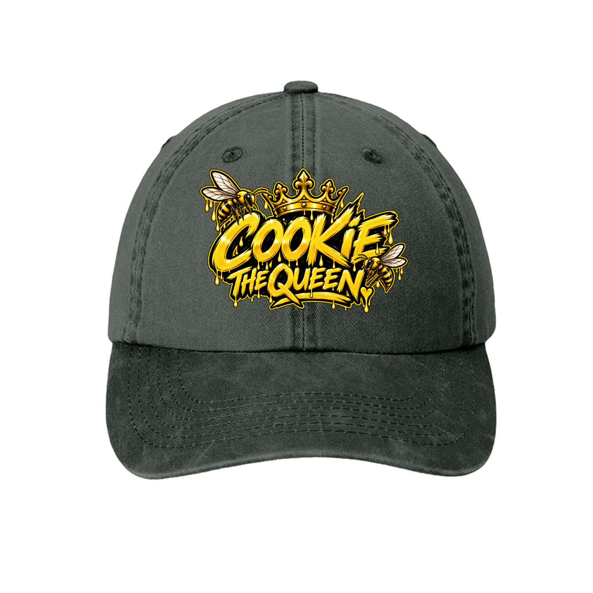A dark gray washed baseball cap featuring a yellow and gold 'COOKIE THE QUEEN' graphic with bee and crown details on the front