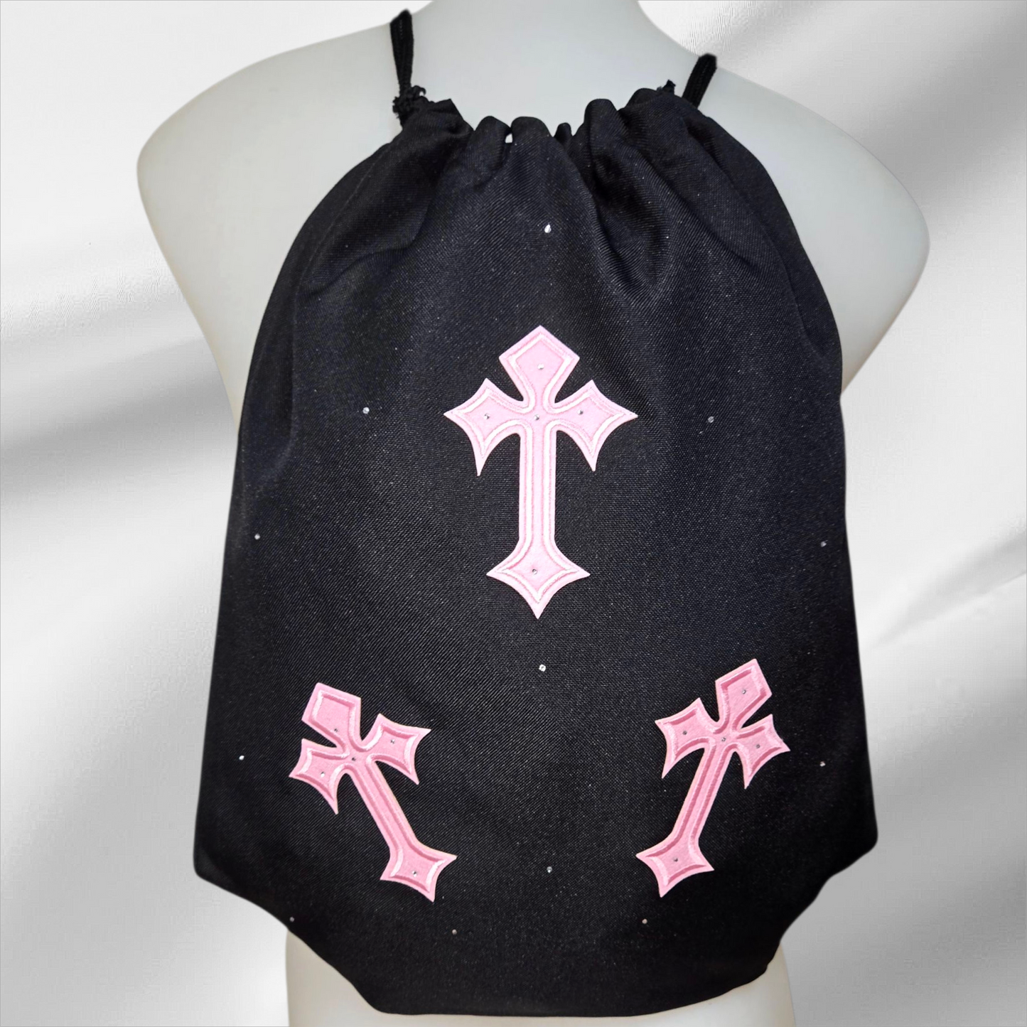 Black drawstring bag with pink crosses and embellished in rhinestones
