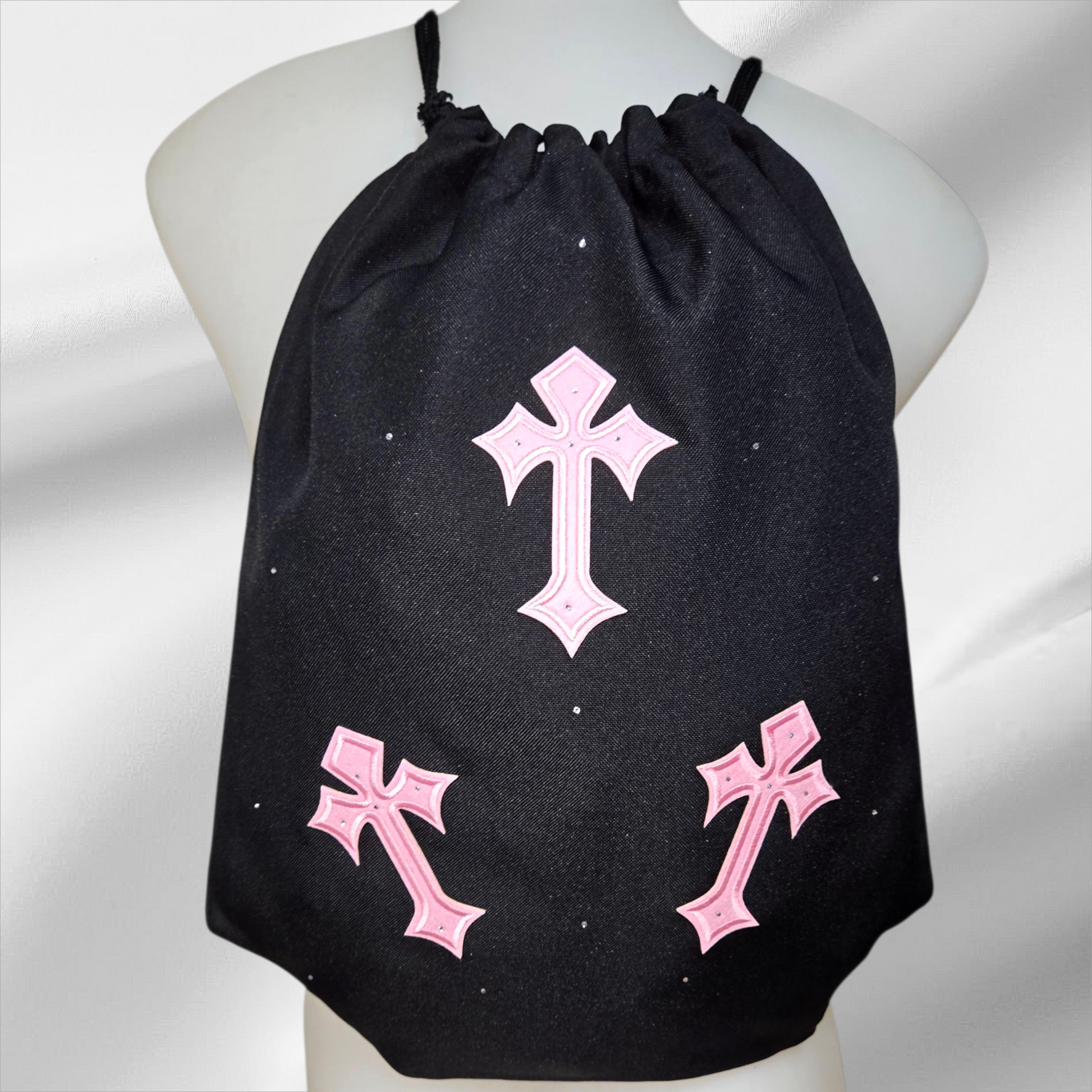 Black drawstring bag with pink crosses and embellished in rhinestones